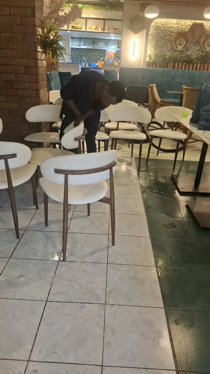 A team member carefully cleaning upholstered seating