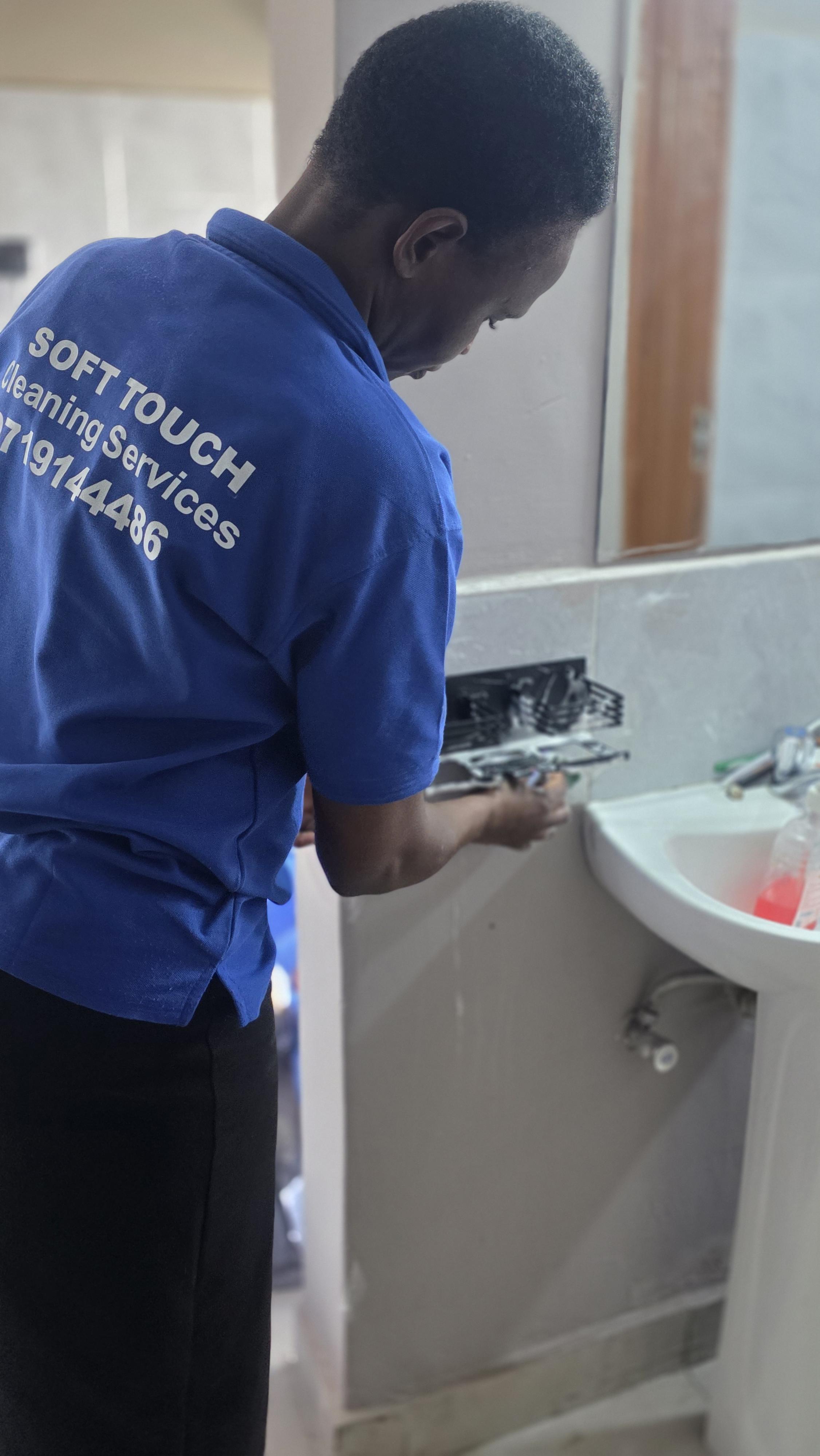 Detailed cleaning around bathroom fittings and the washbasin.