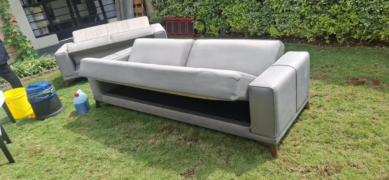 Sofas arranged outdoors with Soft Touch upholstery cleaning equipment